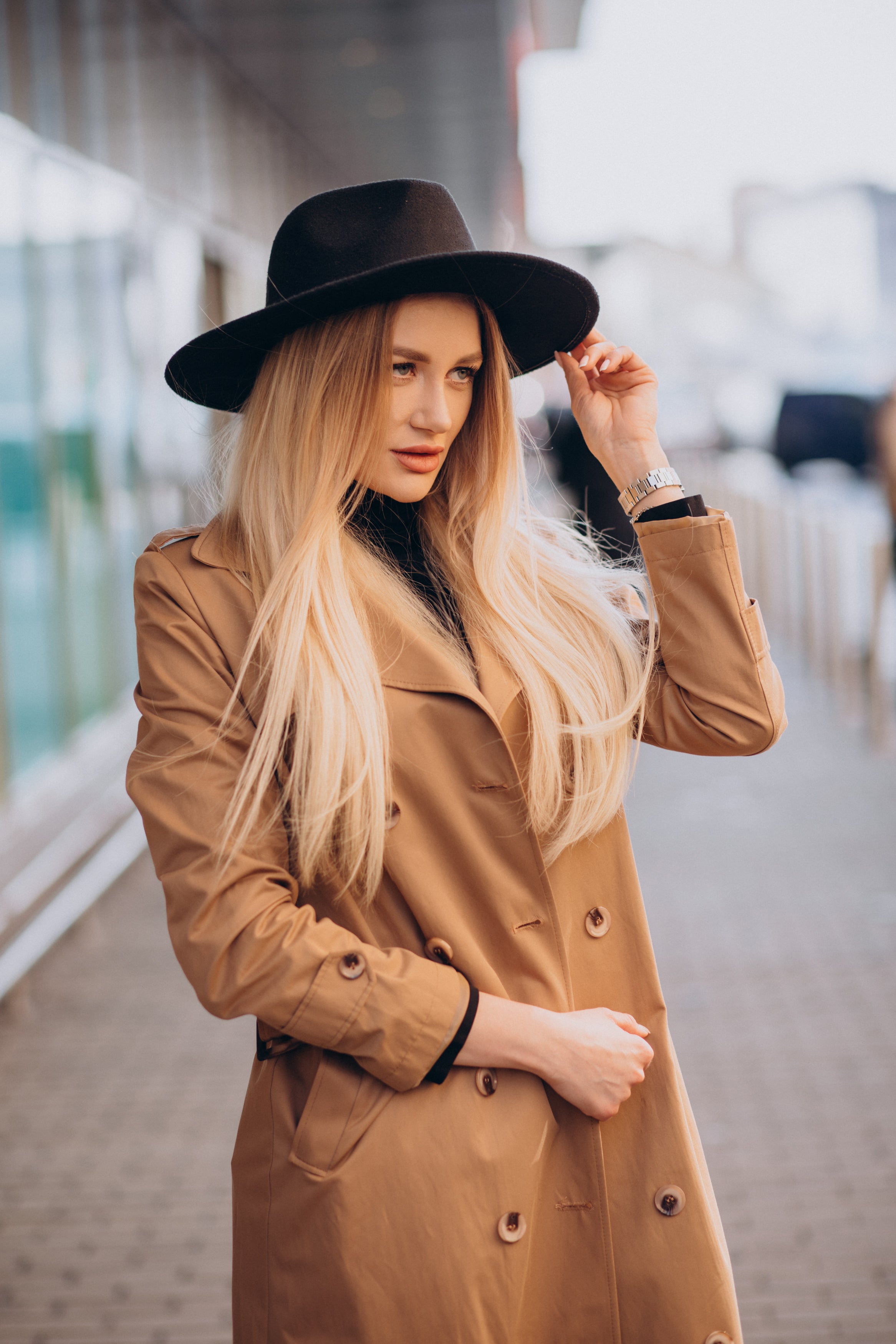young-pretty-woman-black-hat-beige-coat-walking-by-mall.jpg